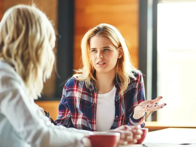 Young person sat having a discussion with adult