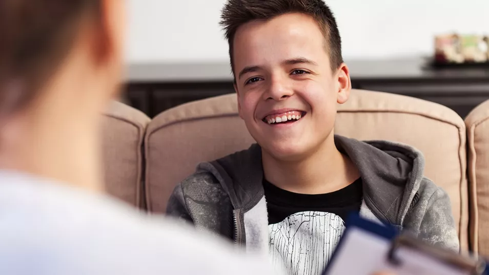 Teenage Boy Smiling During Consultation