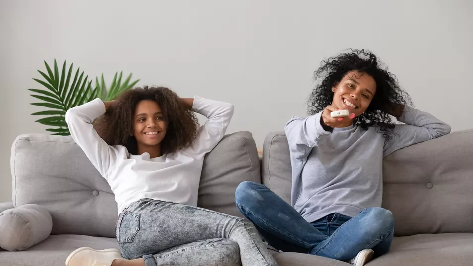 Two Young People Watching TV Together