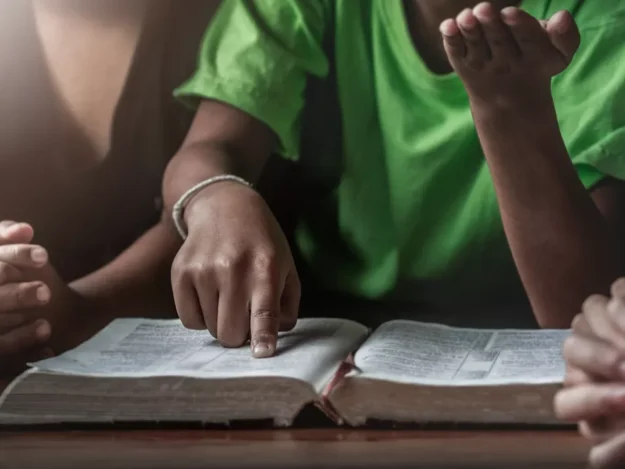 Young People Reading A Bible Together